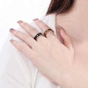 Close-up of two-tone stainless steel rings with small diamonds and The engraving
