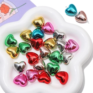 Detailed view of colorful metallic acrylic heart beads with threading holes for DIY jewelry