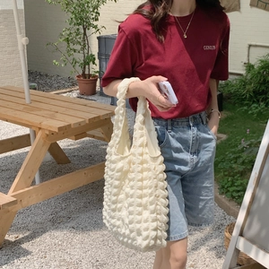 Outdoor shot of cream puff bubble tote bag showing textured detail and capacity