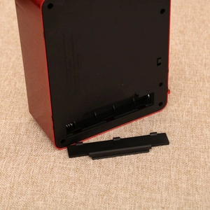 Detail view of the battery compartment and rear control panel of the Christmas TV light box