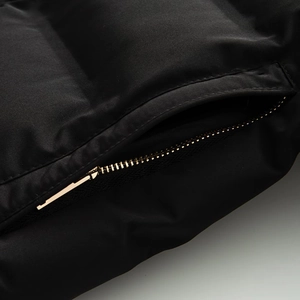 Close-up of premium black quilted jacket featuring a durable metallic zipper and matte fabric