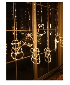 Close-up of LED curtain lights with snowman and star shapes in warm white glow