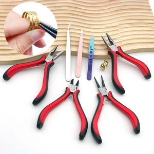 Detail view of mini jewelry pliers and colorful tweezers for DIY craft tool set