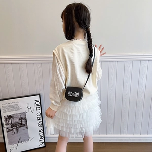 Girls sweet autumn outfit featuring a knit vest and tutu skirt with pearl crossbody bag