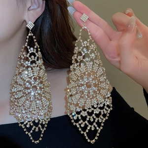 Close-up of sparkling rhinestone long tassel earrings with geometric hollow design