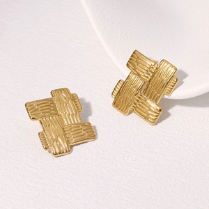 Vintage geometric gold woven texture earrings in stainless steel on white tray