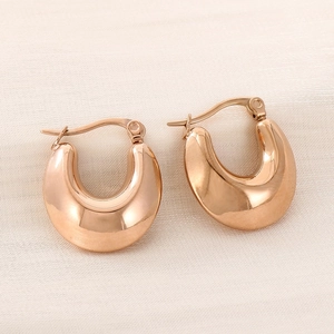 Detailed macro of polished rose gold hollow U-shaped earrings with snap closure