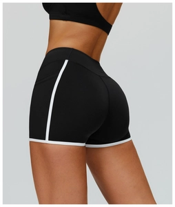 Macro detail of high-waist yoga shorts with contrast white trim and butt-lifting seam