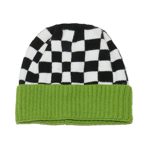 Detail of checkered knit beanie featuring black and white patterns with a neon green cuff