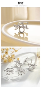 Macro shot of silver bee ear cuff with sparkling zircon wings on ceramic plate