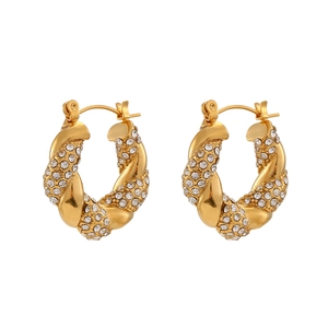 Twisted gold hoop earrings with sparkling cubic zirconia inlay on a clean white background
