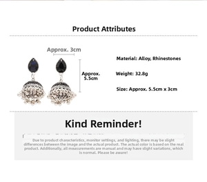 Detailed specs of vintage drop earrings with dark rhinestones and metal bead tassels
