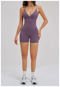 Detail of high-waist purple cross-waist yoga shorts with supportive V-neck sports tank top