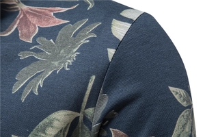 Close-up of polo shirt pique fabric featuring vintage floral print and shoulder seam detail