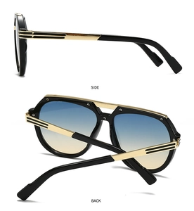 Detail view of modern oversized sunglasses with gold temples and blue-yellow gradient lenses