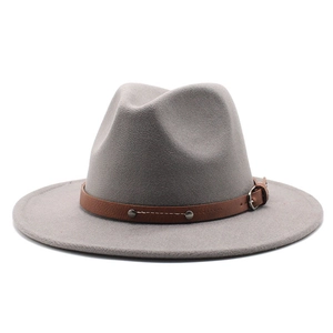Detail of grey felt fedora hat with brown leather band and metallic rivet buckle