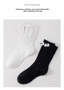 Detail of couple holding hands socks with magnetic arms and 3D eyes on ribbed fabric