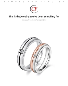 Close-up of minimalist two-tone couple rings with diamonds in silver and rose gold