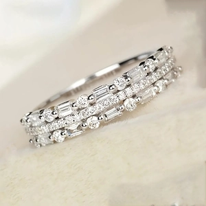 Macro view of multi-layer silver ring with round and baguette-cut cubic zirconia