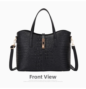 Front view of black crocodile pattern handbag with gold hardware and top handles
