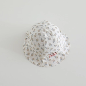 Detailed macro of baby bucket hat cotton fabric with sunflower print and woven brand label