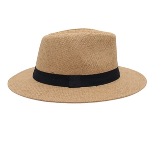 Close-up of finely woven straw fedora hat featuring a classic black decorative ribbon