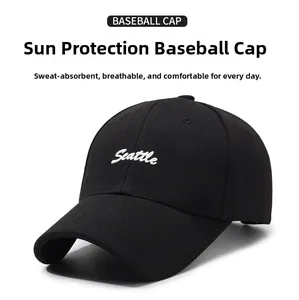 Close-up of Seattle cursive embroidery on a black cotton twill baseball cap with vents