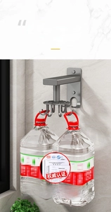 Detail showing high load capacity of grey wall-mounted rotating kitchen hook with water jugs