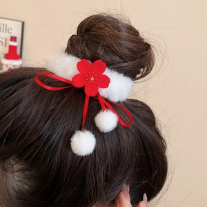 Detail of red flower plush hair scrunchie with white faux fur on a hair bun