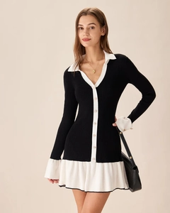 Detail of knit dress featuring white contrast lapels and ruffled cuffs on black fabric