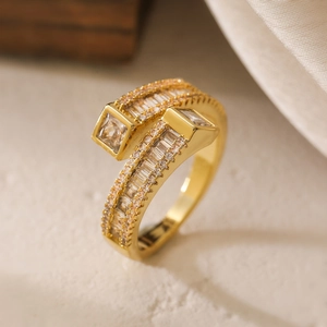Luxurious 18K gold plated bypass ring with baguette and princess cut cubic zirconia