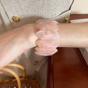 Detailed macro view of the irregular wave resin bracelet with pink marble texture finish