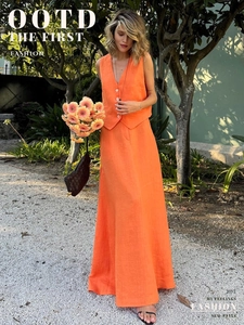 Detail of orange linen-style vest and high-waist A-line skirt with button accents