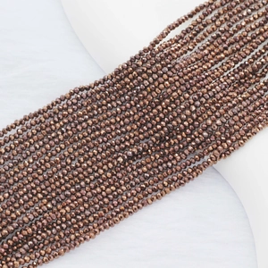 Macro detail of 2mm faceted crystal flat beads in metallic bronze for DIY jewelry making