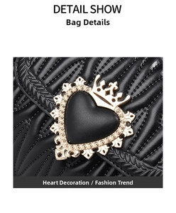 Close-up of golden heart crown clasp on black quilted leather bucket bag detail