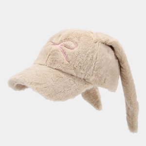 Detail of beige plush baseball cap featuring long floppy rabbit ears and pink embroidery