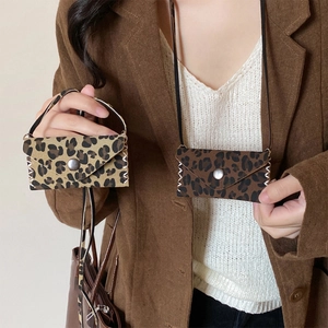 Detail of mini leopard print envelope bag necklace with white stitching and metal clasp