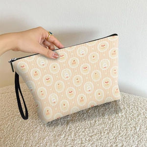 Cute peach pink makeup bag with cartoon rabbit and strawberry prints and wrist strap