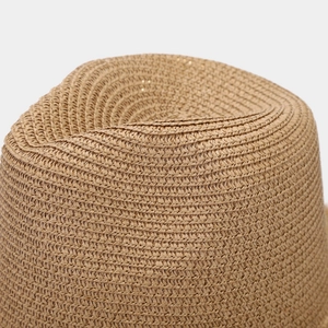 Macro view of detailed straw weaving texture on a brown wide-brim sun hat crown