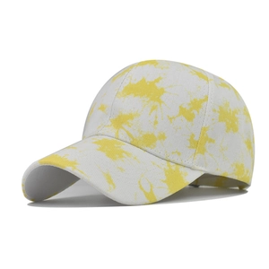 Detail view of cotton tie-dye baseball cap featuring yellow ink splash patterns