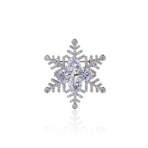 Detailed view of silver snowflake brooch with sparkling zircons and a teardrop diamond center