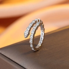 Close-up of a snake-shaped silver ring with sparkling micro-pave cubic zirconia stones