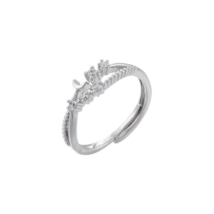 Detail of silver open ring featuring moon and star motifs with clear gemstone inlay