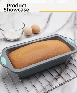 Rectangle silicone bread loaf pan with green handles baking a fresh cake on a cooling rack