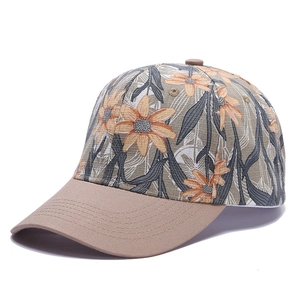 Detailed side view of floral baseball cap with sunflower print and khaki stitching