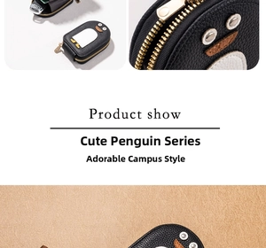 Close-up of penguin coin purse showing lychee grain leather and golden zipper detail