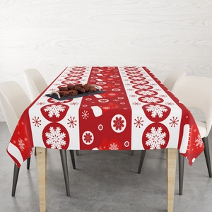 Detail of red Christmas tablecloth with snowflake patterns and fabric texture