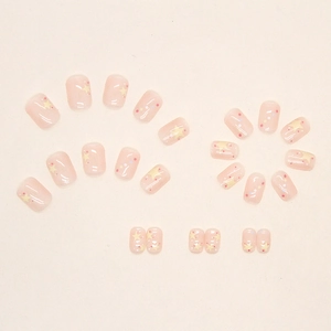 Sweet pink press-on nails with yellow stars and rainbow dots in short square shape