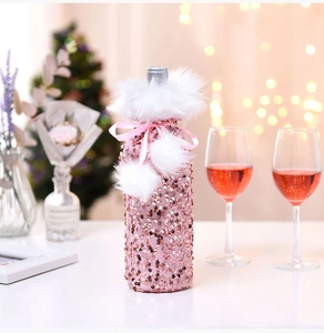 Pink sequin wine bottle cover with faux fur trim and bow for Christmas table decor