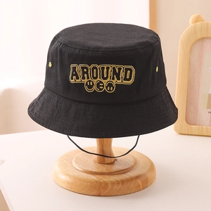 Detail of black cotton bucket hat with yellow AROUND embroidery and adjustable chin strap
